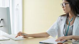 Doctor checking and tracking information on a computer