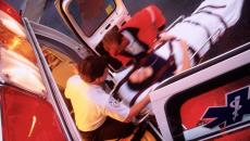EMS technician comes out of an ambulance with patient on a stretcher