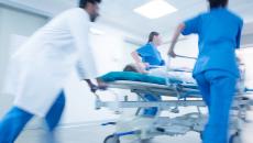 An emergency team pushing a patient on a gurney